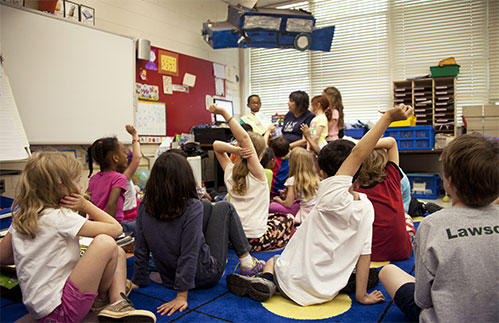 teacher sitting with students